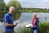Canal & River Trust ecologists Stuart Moodie and Sara Hill use an underwater drone camera to monitor the success of flora and fauna colonisation in the new nature reserve lakes Photo: Canal & River Trust